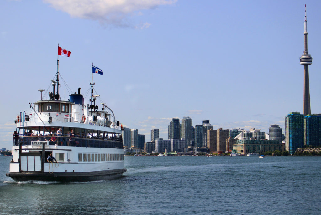 Toronto island ferry sailing with Ontario skyline behind, Canada.