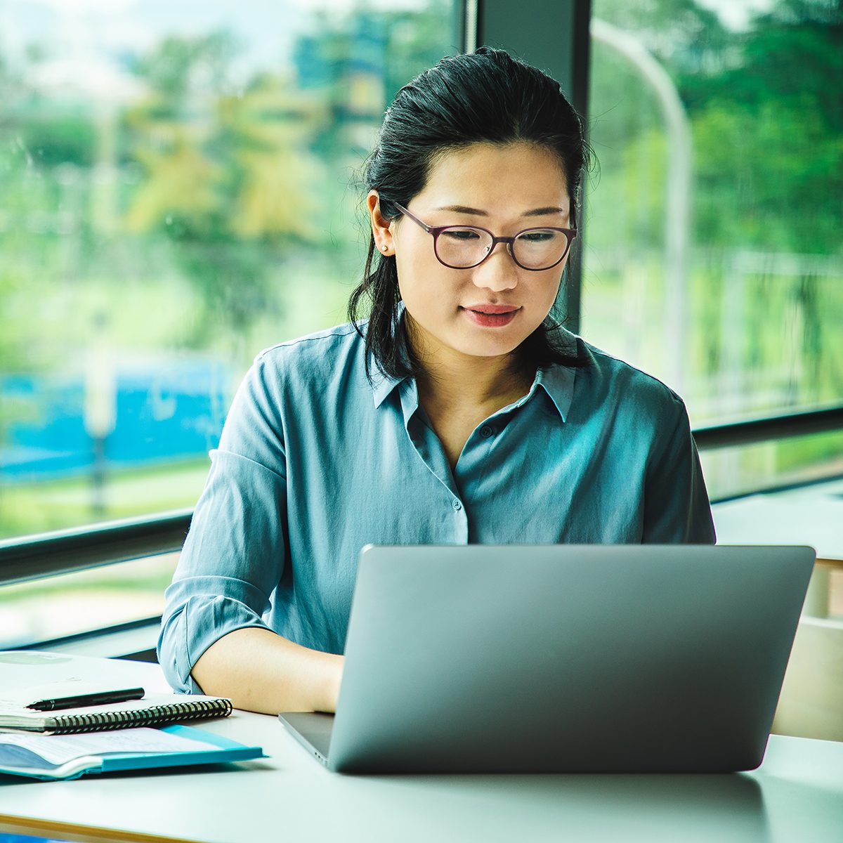 Asian female working on a laptop