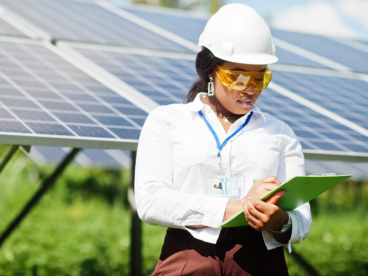 Black woman engineer at solar station.