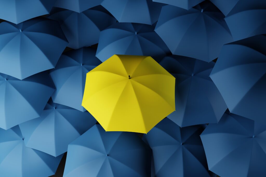 Lots of blue umbrellas and one yellow one that stands out. The concept of differentiation, individuals. 3d rendering, 3d illustration.Lots of blue umbrellas and one yellow one that stands out. The concept of differentiation, individuals. 3d rendering, 3d illustration.